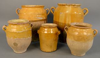 Group of five French earthenware glazed jars, confit pots with handles in mustard yellow, two are large, ht. 8 in. to 14 1/2 in.