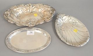 Three sterling silver oval plates, one shell, one repousse with flowers, lg. 11 in., 9 in., 9in., 19.4 troy ounces.
