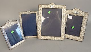 Group of four embossed English silver picture frames, 9 1/2" x 6 1/2" to 14 1/2" x 10 1/2".