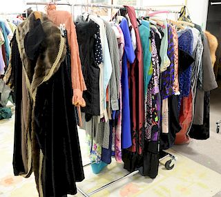 Rack of women's clothing to include vintage dresses by Cassis, Victor Costa for Bergdorf Goodman, along with blouses and jackets by ...