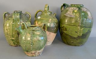 Group of four French earthenware glazed jars confit pots with handles in green glaze and moulded decoration, ht. 10 1/4 in. to 17 in.