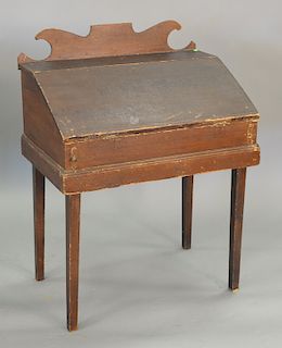 Primitive clerks desk with carved backsplash on tapered legs (in old paint). ht. 40 1/2 in., wd 30 1/2 in.