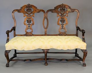 Chippendale style double chair back settee with pierce carved back and ball and claw feet. ht. 48 in., wd. 64 in.
