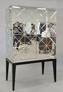 Mirrored two door cabinet on stand, opening to shelved interior. ht. 72 in, wd. 44 1/2 in.