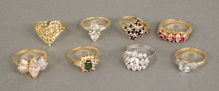 Eight 14 karat gold rings, each set with various stones, 27.8 grams.