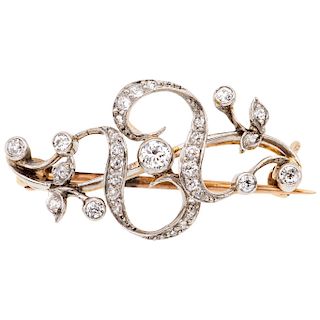 A diamond 14K white and yellow gold brooch.