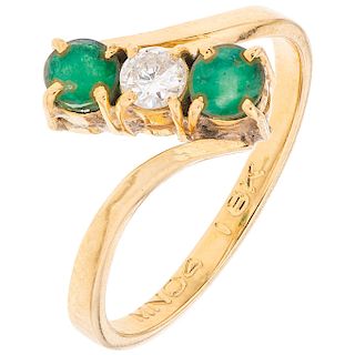 A diamond and emerald 18K yellow gold ring.