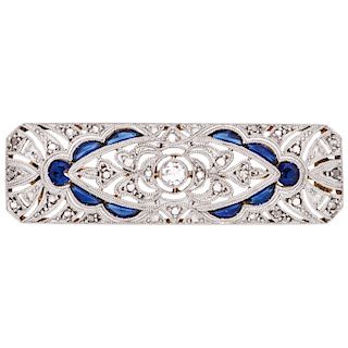 A diamond and sapphire 18K yellow gold brooch.