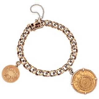 An 18K yellow gold bracelet and pendant with 21.6K yellow gold coin.