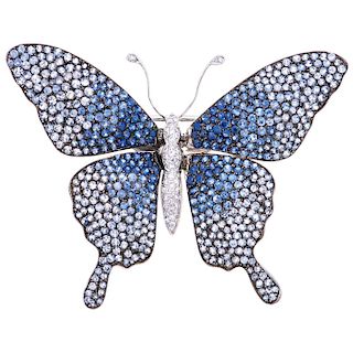 A sapphire and diamond 18K white gold brooch.