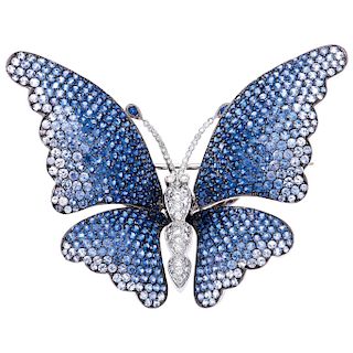 A sapphire and diamond 18K white gold brooch.