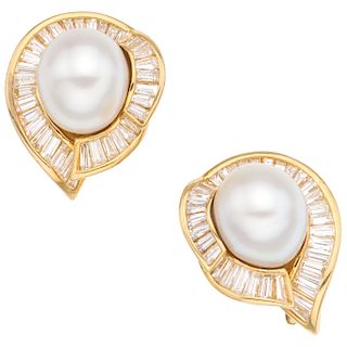 A cultured pearl and diamond 18K yellow gold pair of earrings.