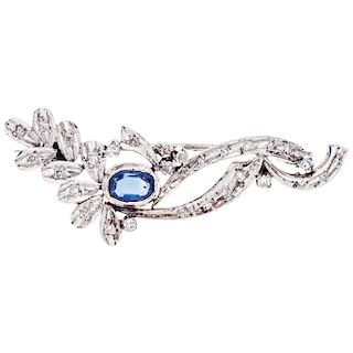 A sapphire and diamond palladium silver brooch.