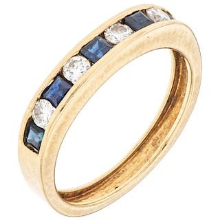 A diamond and sapphire 18K yellow god ring.