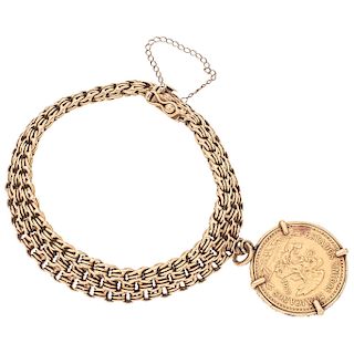 An 18K yellow gold bracelet with 21.6K yellow gold coin.