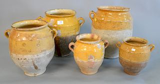 Group of five French earthenware glazed jars, confit pots with handles in mustard yellow glaze, three are large, ht. 8 1/4 in. to 14...