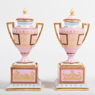 Pair of Vienna Porcelain Pink Ground Urns and Covers Decorated with Mythological Scenes