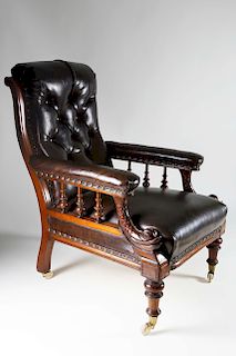 ENGLISH CARVED MAHOGANY AND LEATHER UPHOLSTERED LIBRARY ARM CHAIR