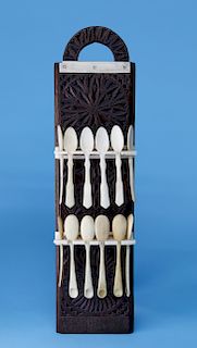 WALRUS IVORY AND CARVED OAK HANGING SPOON RACK WITH 12 ASSEMBLED BONE SPOONS