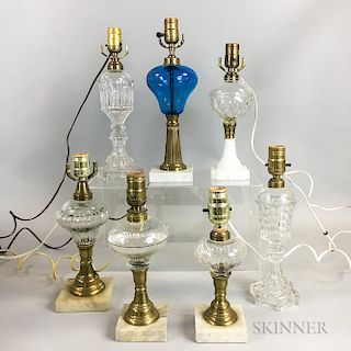 Seven Mostly Colorless Pressed Glass Fluid Lamps