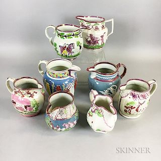 Eight Relief-molded Pink Lustre Ceramic Jugs