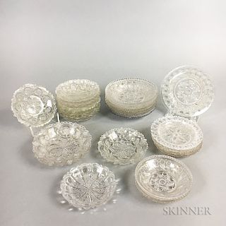 Twenty-six Sandwich Colorless Lacy Pressed Glass Cup Plates.  Estimate $200-300