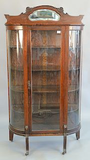 Oak bowed glass china cabinet. ht. 72 in., wd. 39 in.
