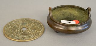 Two Chinese bronze pieces to include censer with handles on three footed base with seal mark on bottom and a disc form plaque (dia. 4 in.).