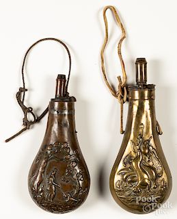 Two embossed brass powder flasks