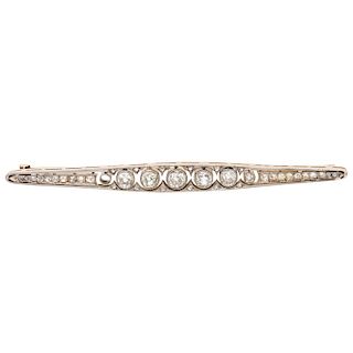 A diamond 14K and 10K yellow gold brooch.