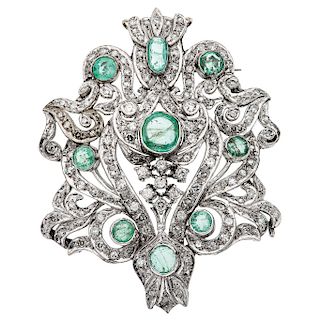 An emerald and diamond palladium silver pendant / brooch.
