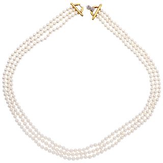 A cultured pearl necklace with diamond and ruby 18K yellow gold clasp.