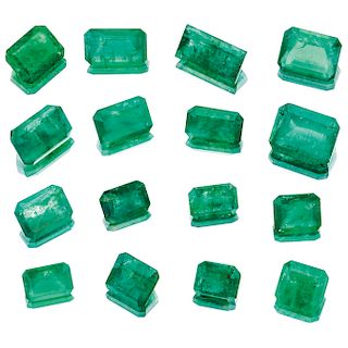 Sixteen loose emeralds.