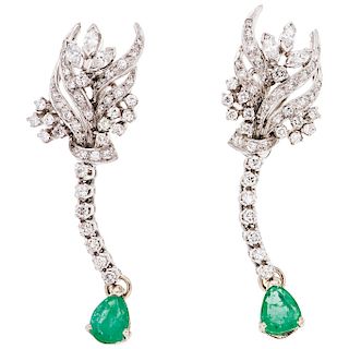 An emerald and diamond palladium silver pair of earrings.