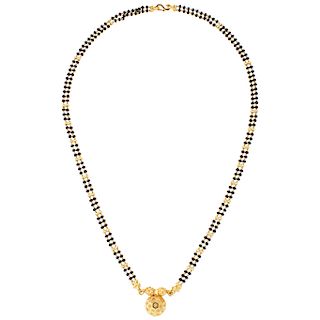 An obsidian 22K yellow gold necklace.