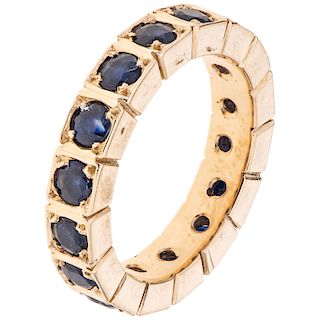 A sapphire 14K yellow gold eternity ring.