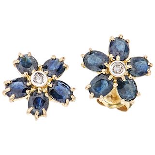 A sapphire and diamond 14K yellow gold pair of stud earrings.