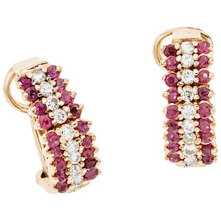 A ruby and diamond 14K yellow gold pair of earrings.