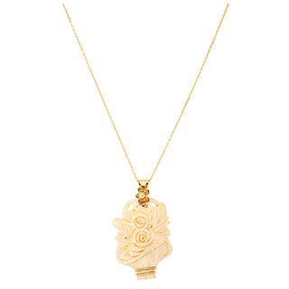 A bone 14K yellow gold pendant and necklace.