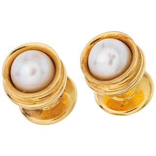 A cultured pearl 18K yellow gold pair of stud earrings.