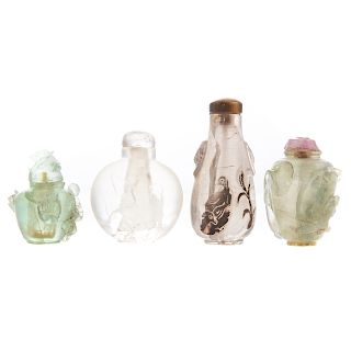 Four Chinese Carved Glass or Stone Snuff Bottles