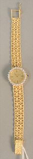 14K gold ladies wristwatch with mesh 14K gold band, dial with diamond surrounding, lg. 6 1/8 in, total weight: 35.4 gr.