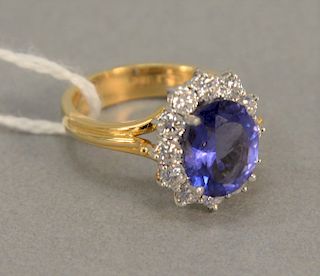 18K gold ring set with oval center Tanzanite surrounded by diamonds, 6.1 gr.