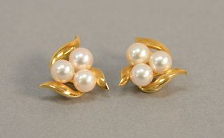 Pair of 18K gold earrings set with three pearls each, 7.7 gr.