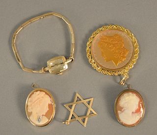 Five piece lot to include two cameo pins, one gold, 14K gold star of David pendant, 14K gold ladies wristwatch and replica Morgan dollar.