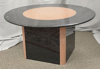 Round granite table, mixed black and tan marble having square base and round top. ht. 30 in., dia. 60 in. Provenance: Estate from Lo...