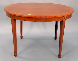 Kindel oval mahogany extending table, 38" x 44" with three extra 16" leaves which opens to 44" x 86" with banded top.