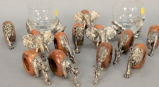 Fourteen piece lot to include set of twelve wooden napkin rings, each mounted with pewter African animals; elephant, lion, giraffe, ...