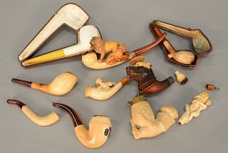 Collection of ten Meerschaum pipes including dog, lion, lioness, female figure, etc.