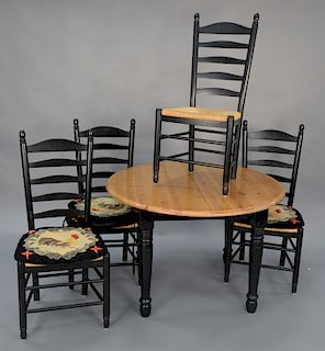 A five piece set to include a round pine table and four ladder back chairs. ht. 30 in., dia. 45 in., made in Italy.